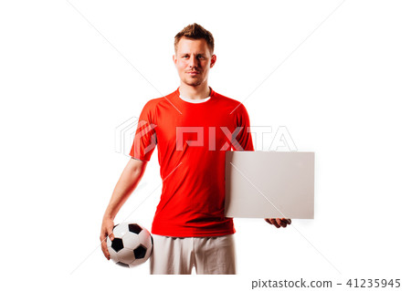 Young handsome football player soccer holds ball and white blank on white. Young handsome football player soccer holds ball and white blank on white. 41235945