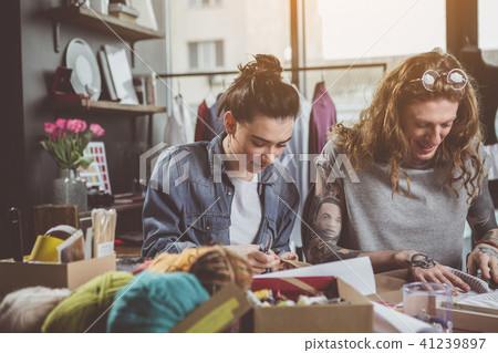 Laughing dressmakers talking during job 41239897