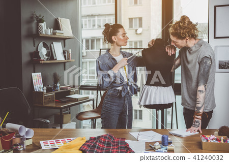 Outgoing girl and man measuring mannequin Outgoing girl and man measuring mannequin 41240032