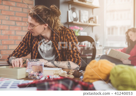 Focused male designer noting at table Focused male designer noting at table 41240053
