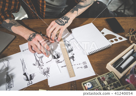 Man arms drawing pictures of dresses Man arms drawing pictures of dresses 41240054