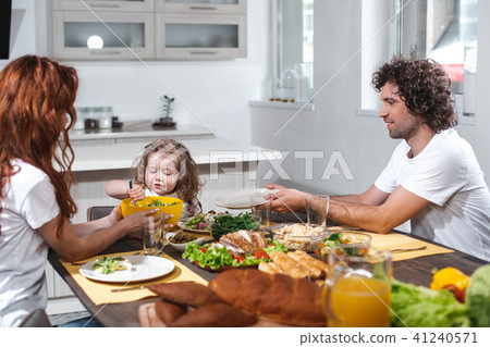 Happy father and mother feeding her child by healthy food Happy father and mother feeding her child by healthy food 41240571