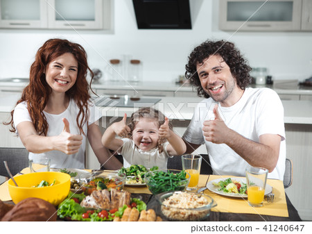 Cheerful parents and child showing ok sign while eating Cheerful parents and child showing ok sign while eating 41240647