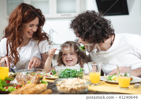 Friendly family having funny lunch together at home Friendly family having funny lunch together at home 41240649