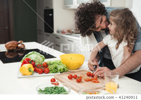 Happy family cutting vegetables for lunch  41240911