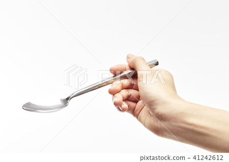 woman's right hand holds a spoon woman's right hand holds a spoon 41242612