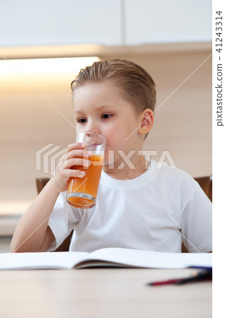 Little boy drinking fresh orange juice 41243314