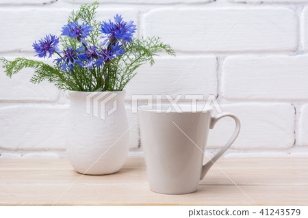 White coffee latte mug mockup cornflower in vase White coffee latte mug mockup cornflower in vase 41243579