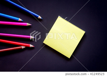 Paper with crayon on black backgrounds Paper with crayon on black backgrounds 41249523