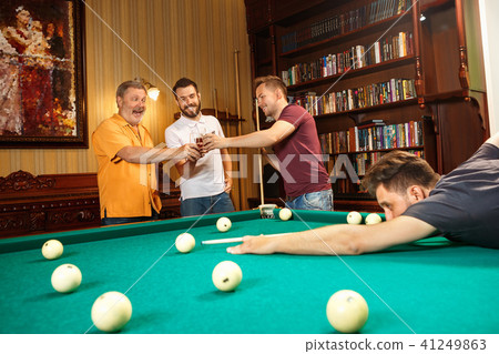Close-up shot of a man playing billiard Close-up shot of a man playing billiard 41249863