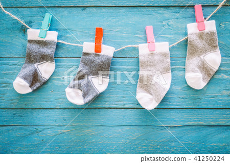 Baby socks on a wooden background Baby socks on a wooden background 41250224