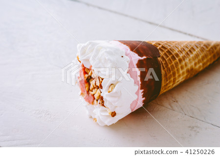Ice cream strawberry in waffle cone on  wooden  41250226