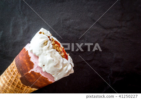 Ice cream strawberry in waffle cone on black Ice cream strawberry in waffle cone on black 41250227