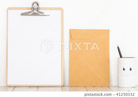 Paper in clipboard and notebook on wooden table 41250332