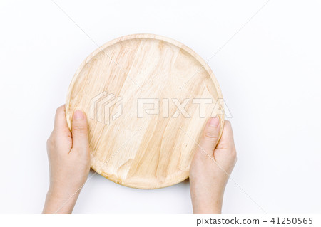 Woman hands holding  empty wooden plate  on white 41250565