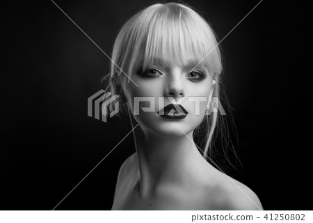 Black and white studio portrait of a girl with evening make up. 41250802