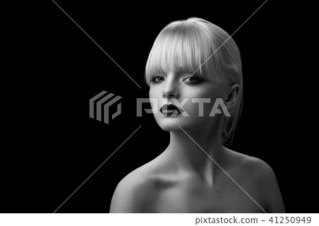 Black and white portrait of pretty girl with blonde hair and evening make up. Black and white portrait of pretty girl with blonde hair and evening make up. 41250949