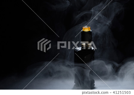 vape close-up in a smoke on a black background vape close-up in a smoke on a black background 41251503