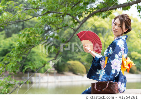 A woman with a yukata with a fan A woman with a yukata with a fan 41254261
