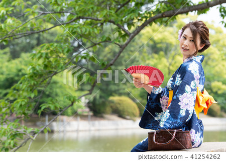 A woman with a yukata with a fan A woman with a yukata with a fan 41254262