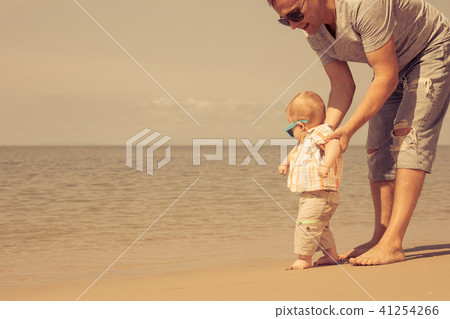Father and baby son playing on the beach at the day time. 41254266