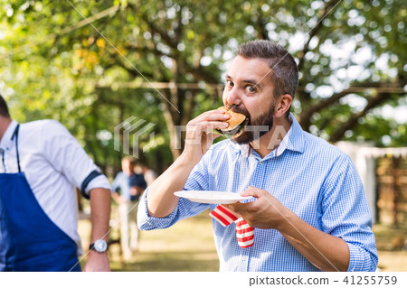 Family celebration or a barbecue party outside in the backyard. Family celebration or a barbecue party outside in the backyard. 41255759