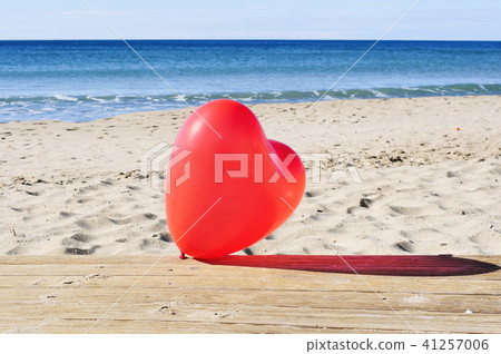 red heart-shaped balloon on the beach red heart-shaped balloon on the beach 41257006