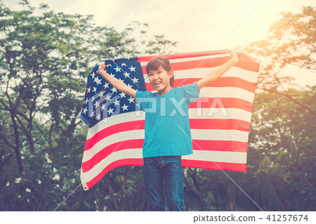 Happy kid little child running with American flag Happy kid little child running with American flag 41257674