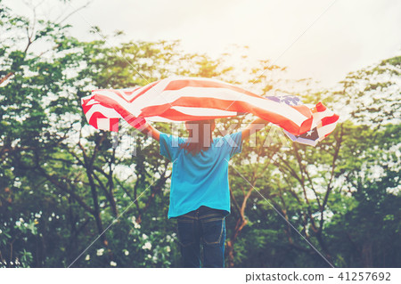 Happy kid little child running with American flag Happy kid little child running with American flag 41257692