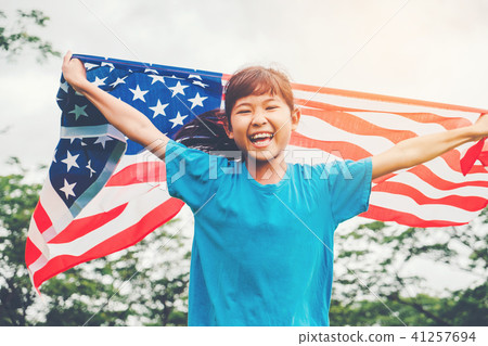 Happy kid little child running with American flag Happy kid little child running with American flag 41257694