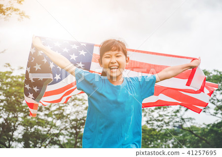 Happy kid little child running with American flag Happy kid little child running with American flag 41257695