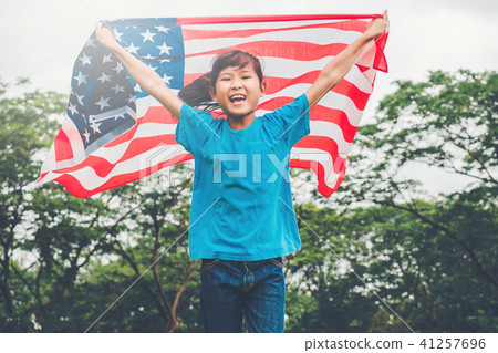 Happy kid little child running with American flag Happy kid little child running with American flag 41257696