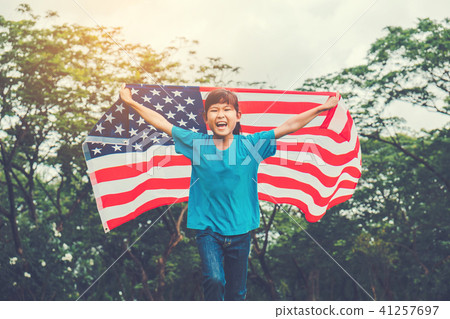 Happy kid little child running with American flag Happy kid little child running with American flag 41257697