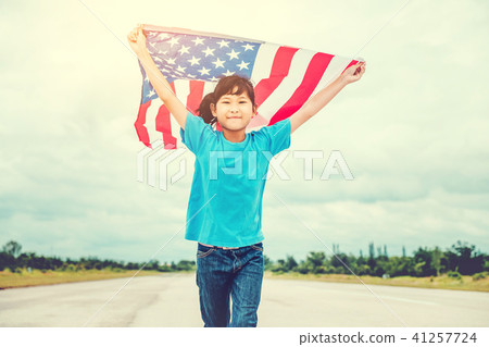 Happy kid little child running with American flag Happy kid little child running with American flag 41257724