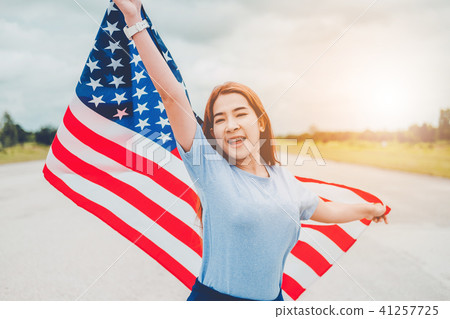 Happy woman standing with American flag 41257725
