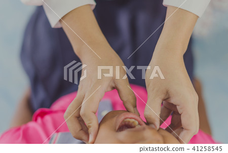 Doctor is checking the oral cavity of a student 41258545