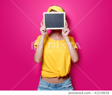 Girl in yellow t-shirt with little blackboard Girl in yellow t-shirt with little blackboard 41259038