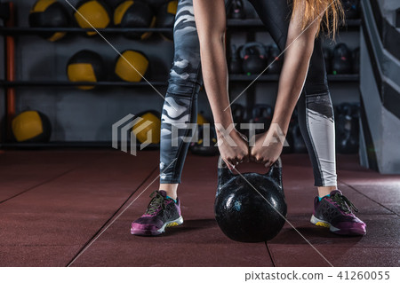Crossfit kettlebell training in gym. Crossfit kettlebell training in gym. 41260055