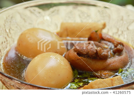 boiled egg with pork leg in herb brown soup  41260575