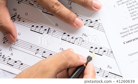 song composer working on music note paper song composer working on music note paper 41260639