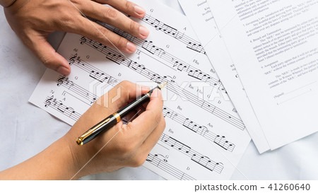 song composer working on music note paper song composer working on music note paper 41260640
