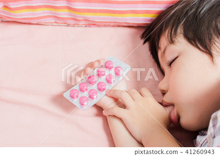 Little Asian Boy Sleep with Medicine panel in hand. 41260943