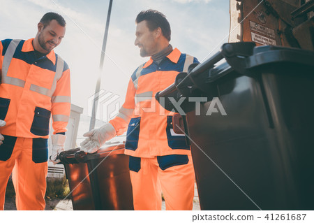 Garbage removal men working for a public utility 41261687