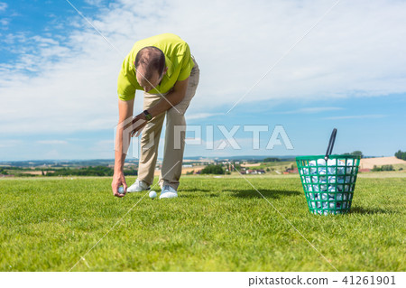Close-up of the hand of a professional male golf player taking a ball Close-up of the hand of a professional male golf player taking a ball 41261901