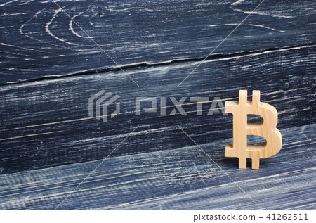 Wooden Bitcoin on a background of black boards Wooden Bitcoin on a background of black boards 41262511