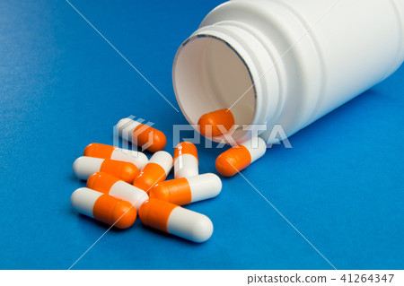 Orange white capsules (pills) Orange white capsules (pills) 41264347