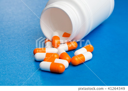 Orange white capsules (pills) Orange white capsules (pills) 41264349
