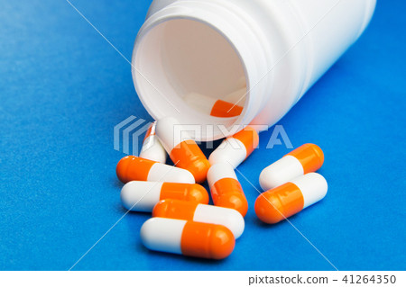 Orange white capsules (pills) Orange white capsules (pills) 41264350