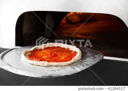 Italian pizza is cooked in a wood-fired oven. Close up Italian pizza is cooked in a wood-fired oven. Close up 41264517