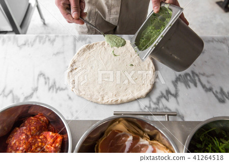 Fresh original Italian raw pizza, preparation in traditional style. Hands of chef baker making pizza Fresh original Italian raw pizza, preparation in traditional style. Hands of chef baker making pizza 41264518